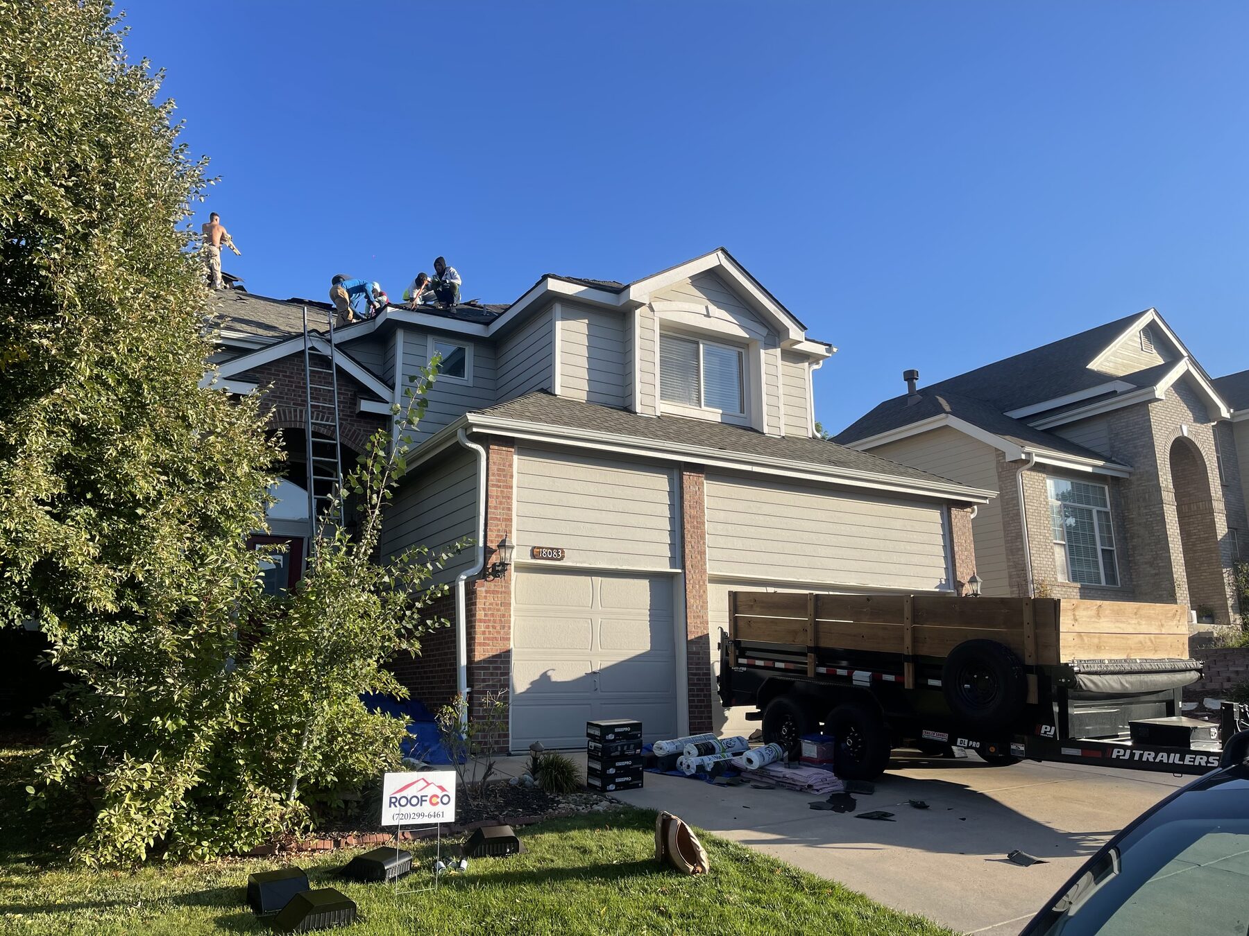 Roofco team in front of a Denver project