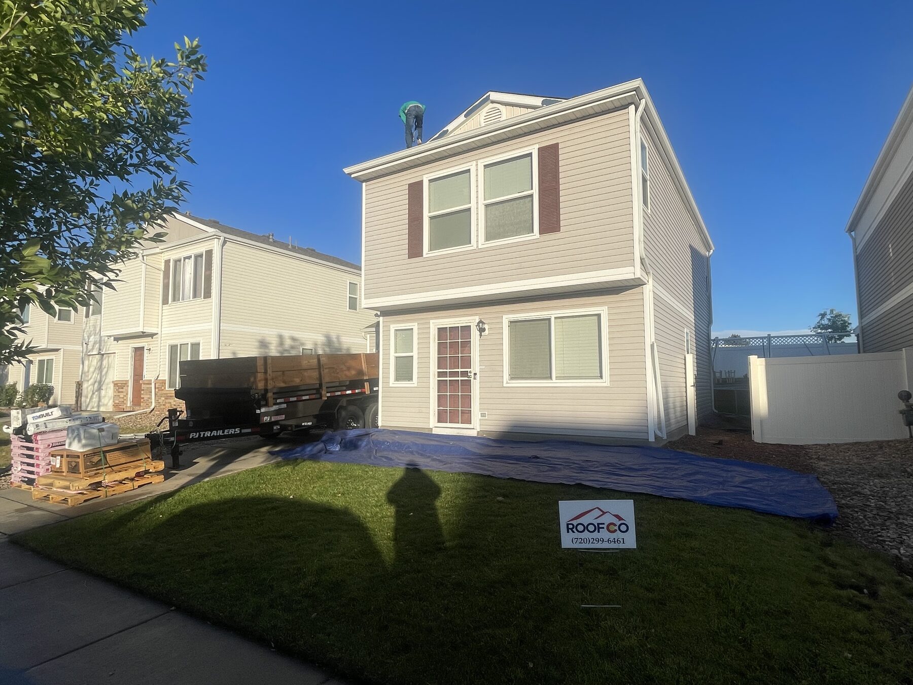 Roofer repairing shingles on a Denver home